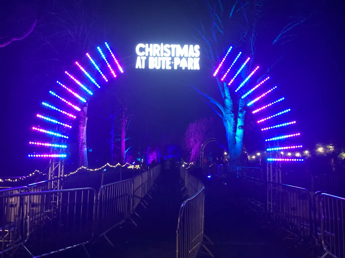 Christmas at Bute Park entrance arch lit in neon colours