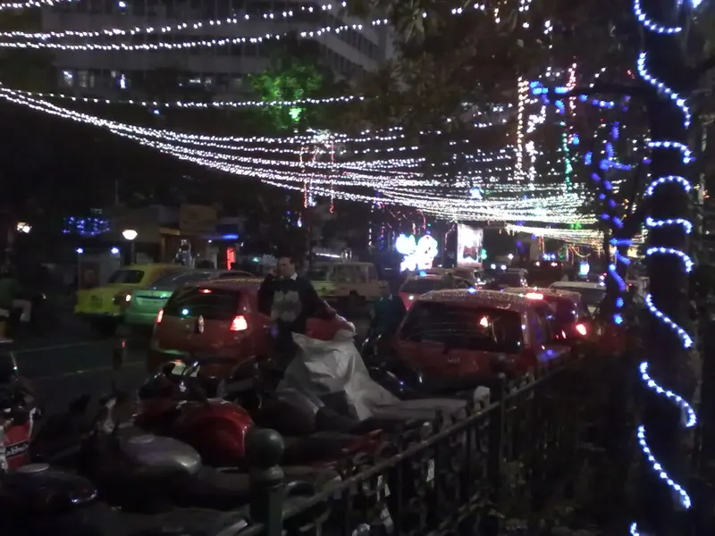 Christmas light strings and decorations along Park Street at night, Kolkata