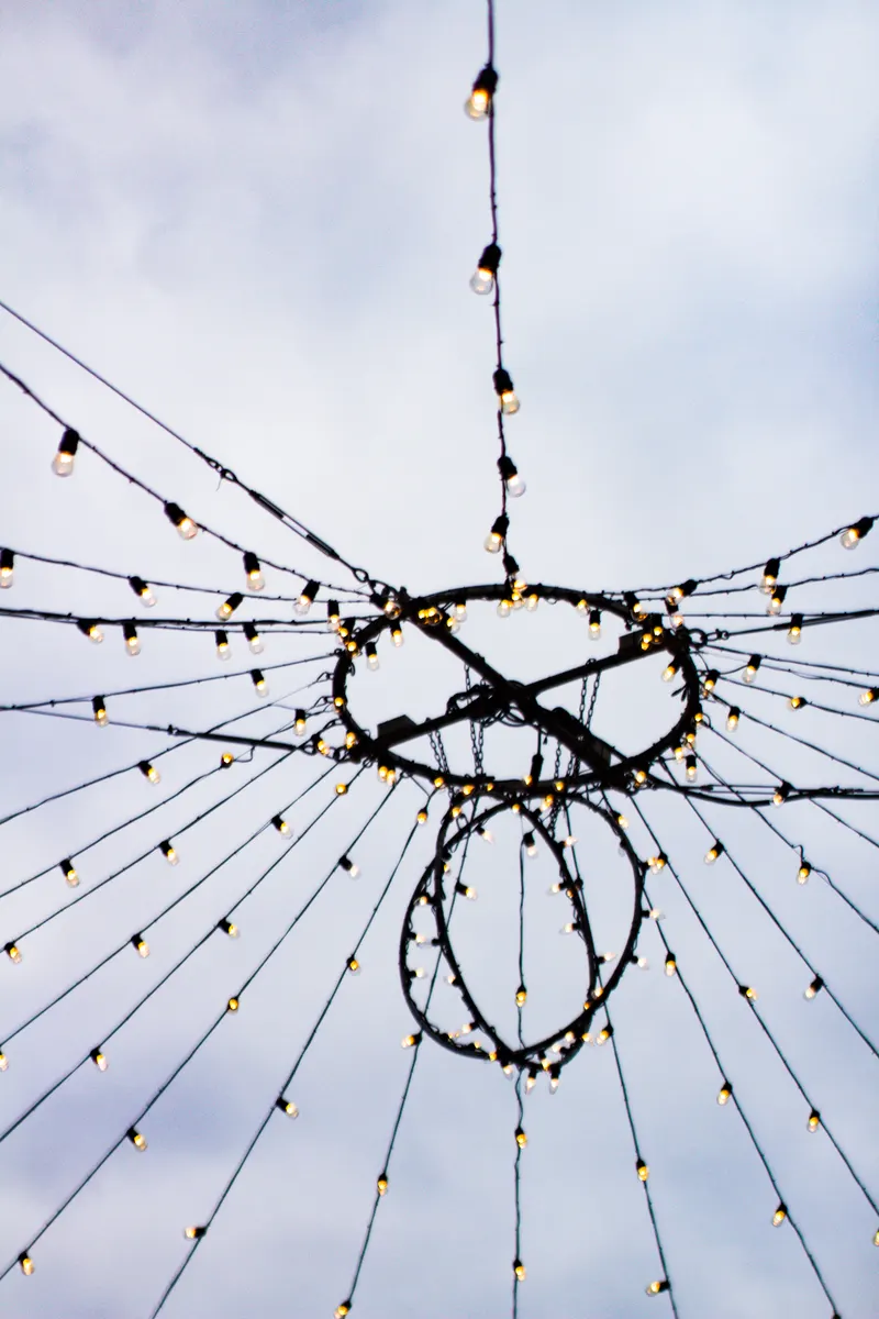 Strings of lights overhanging the main pathway of the Distillery District Christmas market