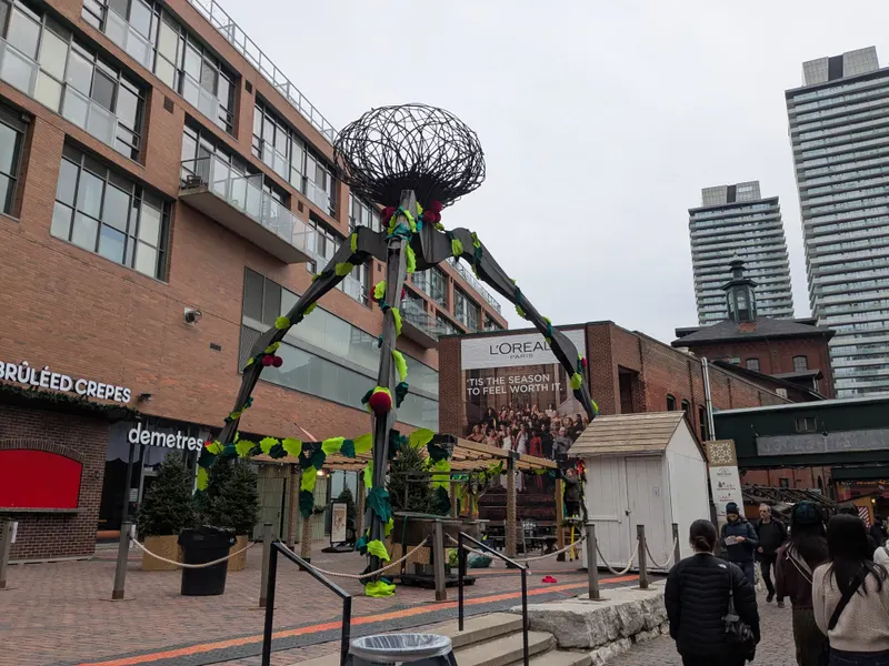 Giant spider sculpture decorated with holly for the Distillery Winter Village, Toronto