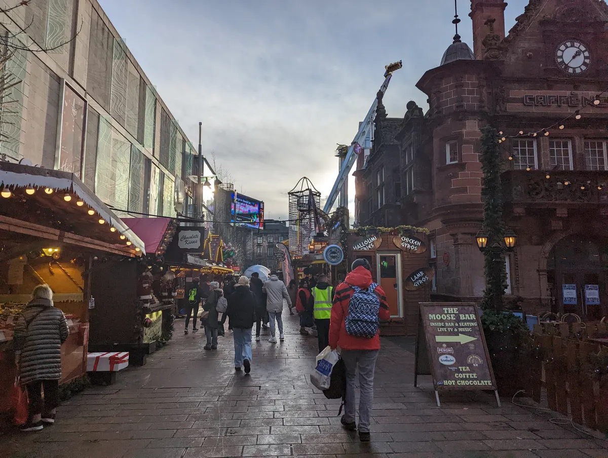 Wooden Christmas market chalets on a Glasgow city centre street