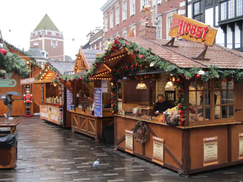 Wooden chalets with garlands at Kingston German Christmas Market
