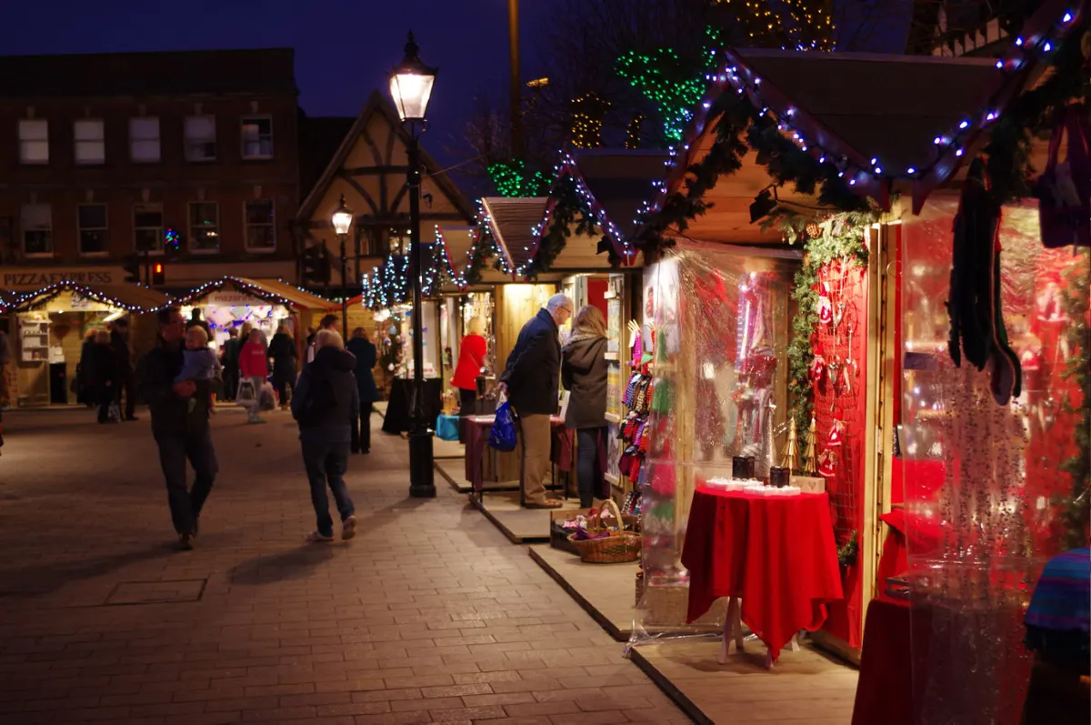 Illuminated stalls at Salisbury Christmas Market in the evening