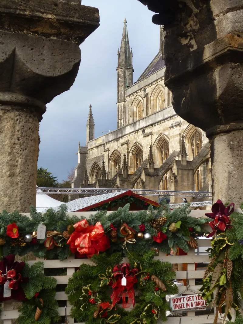 Festive garland on a chalet with Winchester Cathedral behind