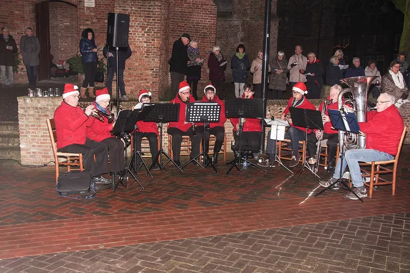 Muziekband in kerstmutsen bij de dorpskerk van Spijkenisse