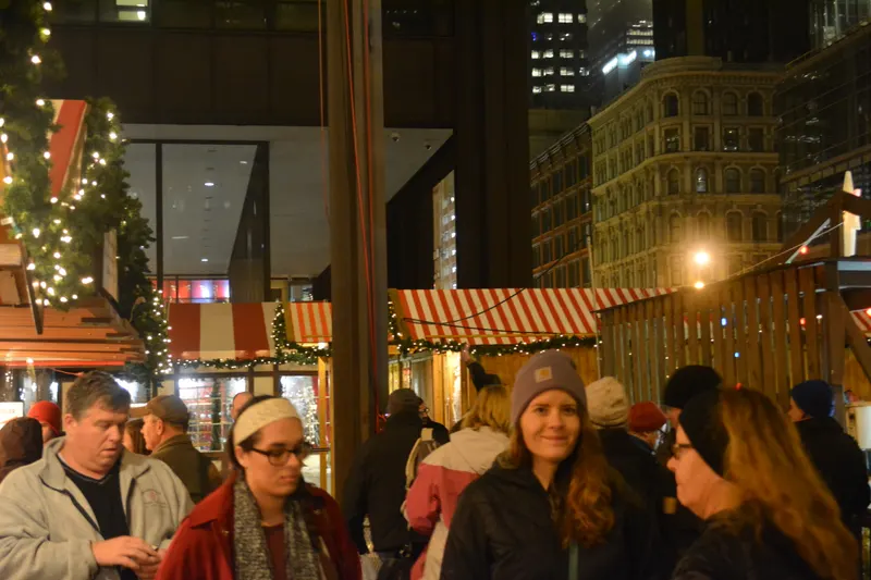 Visitors in winter coats among the festive stalls at Christkindlmarket Chicago