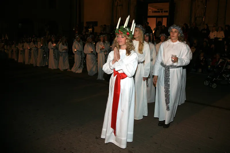 Lucia procession with candle crown in Balboa Park during December Nights